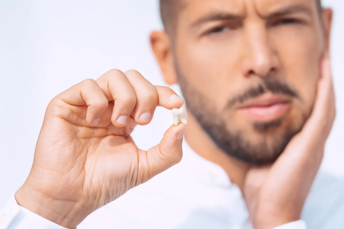 Post-Wisdom Teeth Extraction Care: Tips for Plano Residents, Plano, TX Person resting with ice pack on cheek after wisdom teeth removal